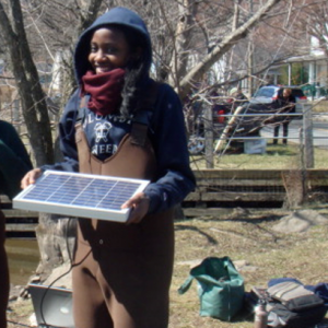 Rebecca sets up hydrology monitoring equipment out on site