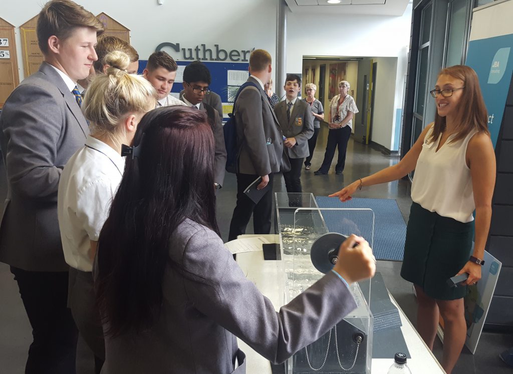 Rebecca uses the wave tank to show how coastal flood risk can be managed